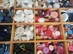 Wooden tray of colourful buttons