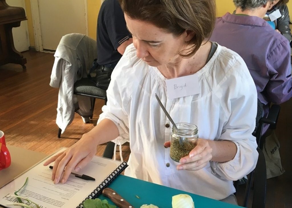 Woman reading instructions, holding jar of herbs