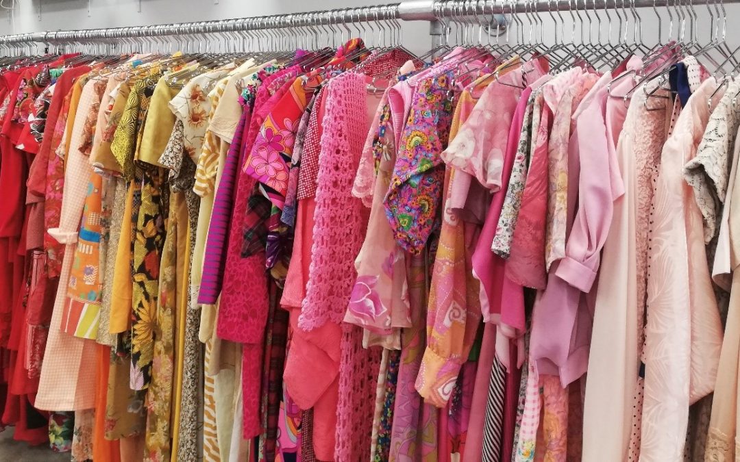 a long rack of colourful clothing